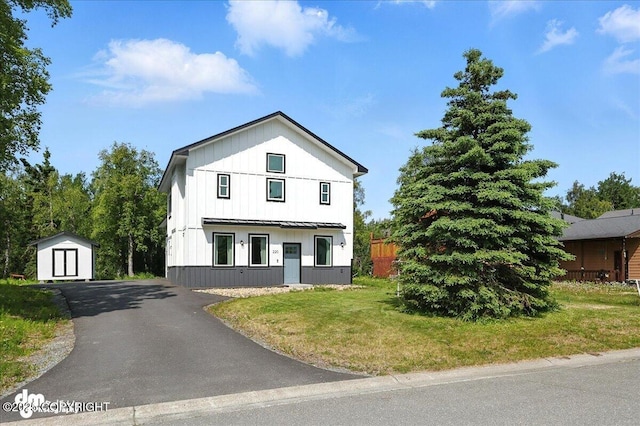 220 Susieana Ln, Kenai, AK 99611 - modern inspired farmhouse with a storage shed, board and batten siding, a front yard, a metal roof, and a standing seam roof