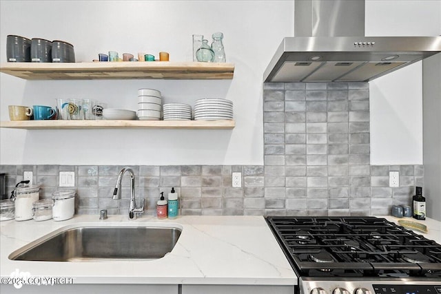 220 Susieana Ln, Kenai, AK 99611 - kitchen featuring open shelves, wall chimney range hood, stainless steel range with gas cooktop, light stone countertops, and backsplash