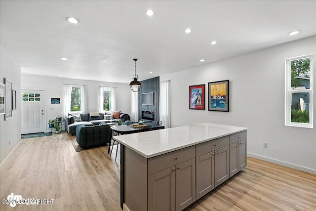220 Susieana Ln, Kenai, AK 99611 - kitchen featuring gray cabinets, light wood finished floors, recessed lighting, a kitchen island, and healthy amount of natural light