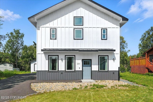 220 Susieana Ln, Kenai, AK 99611 - modern farmhouse style home with board and batten siding, a front yard, a standing seam roof, and a metal roof