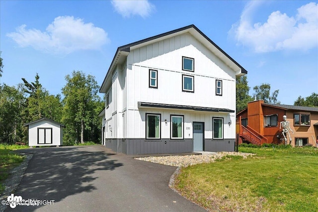 220 Susieana Ln, Kenai, AK 99611 - view of front of property featuring a storage shed, a front yard, asphalt driveway, and board and batten siding