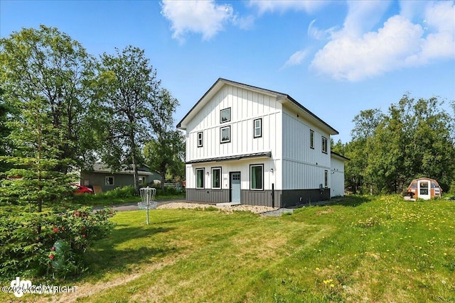 220 Susieana Ln, Kenai, AK 99611 - back of property with board and batten siding and a yard