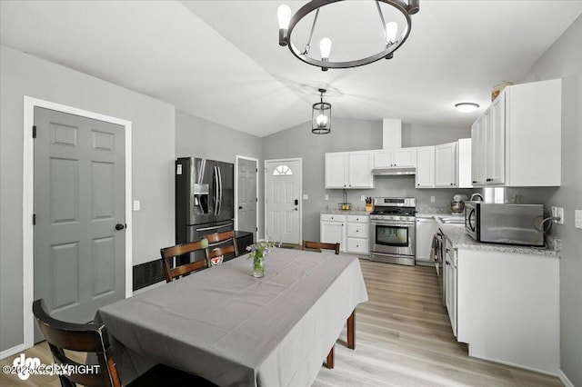 2660 N Jasper Dr, Wasilla, AK 99654 - dining area featuring light wood-style floors, lofted ceiling, and a chandelier
