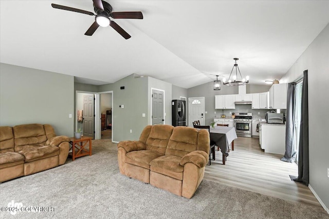 2660 N Jasper Dr, Wasilla, AK 99654 - living room with lofted ceiling, a chandelier, ceiling fan, and light carpet