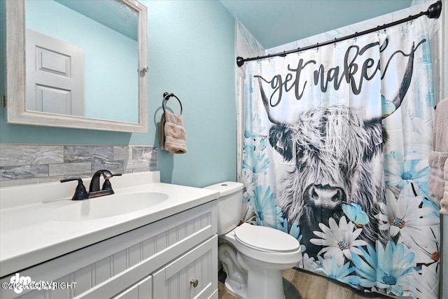 2660 N Jasper Dr, Wasilla, AK 99654 - bathroom with vanity, wood finished floors, a shower with shower curtain, and tasteful backsplash