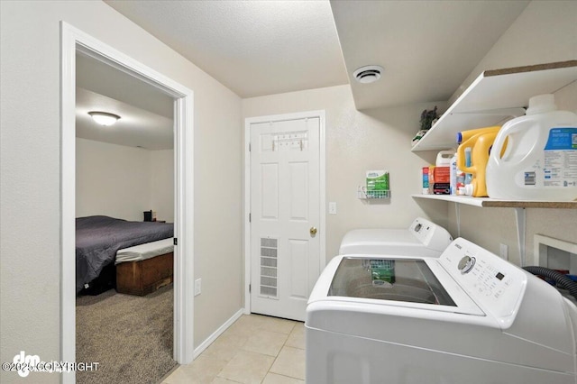 2660 N Jasper Dr, Wasilla, AK 99654 - laundry area with washer and clothes dryer and light tile patterned floors