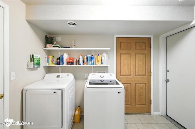 2660 N Jasper Dr, Wasilla, AK 99654 - laundry room with washing machine and clothes dryer and light tile patterned floors