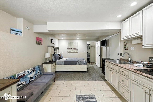 2660 N Jasper Dr, Wasilla, AK 99654 - bedroom featuring light carpet, light tile patterned flooring, recessed lighting, and a textured ceiling