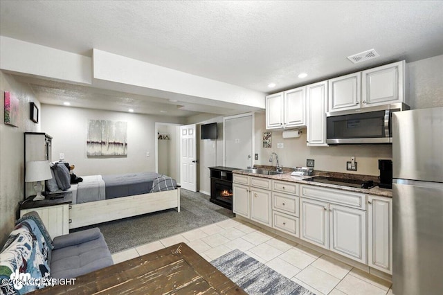 2660 N Jasper Dr, Wasilla, AK 99654 - kitchen with stainless steel appliances, open floor plan, light tile patterned floors, light carpet, and recessed lighting