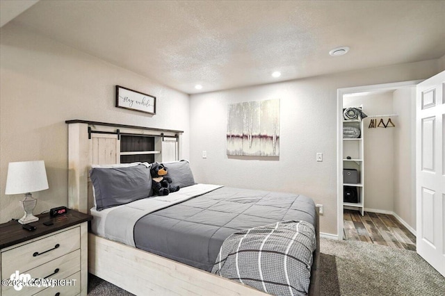 2660 N Jasper Dr, Wasilla, AK 99654 - carpeted bedroom featuring recessed lighting, a textured ceiling, and a spacious closet