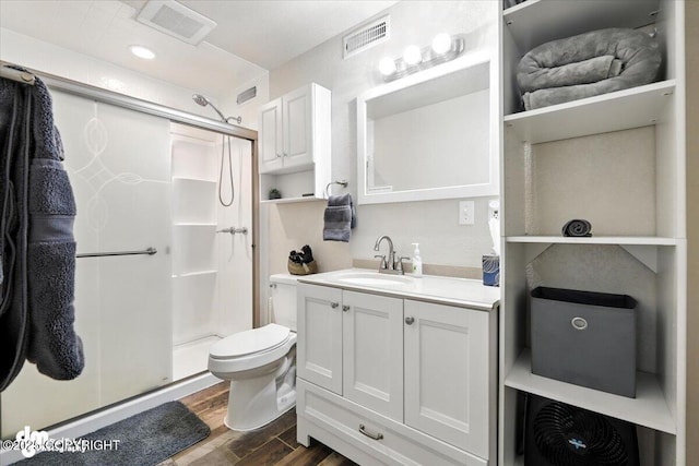 2660 N Jasper Dr, Wasilla, AK 99654 - bathroom with wood finished floors, a shower stall, and vanity