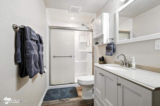 2660 N Jasper Dr, Wasilla, AK 99654 - full bathroom featuring a stall shower, vanity, and wood finished floors