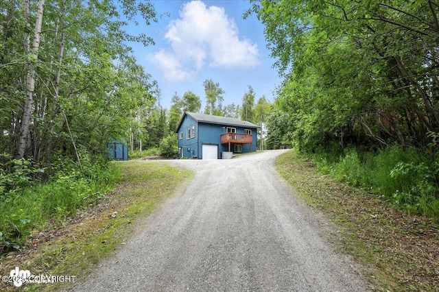 2660 N Jasper Dr, Wasilla, AK 99654 - view of front of property featuring dirt driveway, a garage, and a storage unit