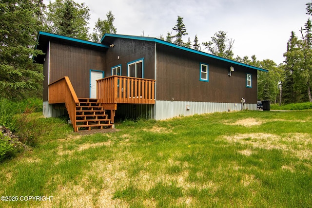 47459 Lakeside St, Nikiski/North Kenai, AK 99611 - back of property featuring a deck, stairs, and a yard