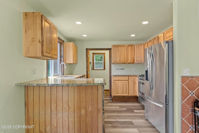 47459 Lakeside St, Nikiski/North Kenai, AK 99611 - kitchen with stainless steel appliances, light wood-style floors, a peninsula, recessed lighting, and light brown cabinets