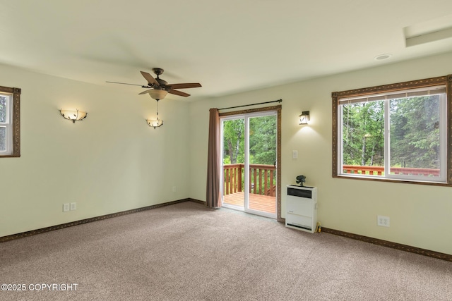 47459 Lakeside St, Nikiski/North Kenai, AK 99611 - empty room featuring heating unit, plenty of natural light, carpet floors, and a ceiling fan