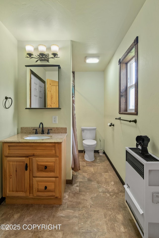 47459 Lakeside St, Nikiski/North Kenai, AK 99611 - bathroom featuring stone finish floors, vanity, and heating unit
