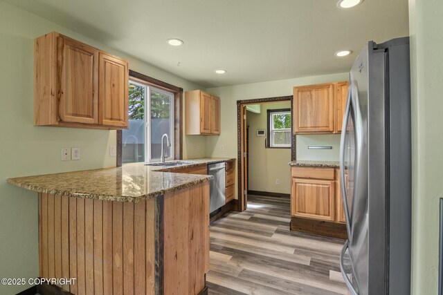 47459 Lakeside St, Nikiski/North Kenai, AK 99611 - kitchen with appliances with stainless steel finishes, healthy amount of natural light, light wood-style flooring, a peninsula, and recessed lighting