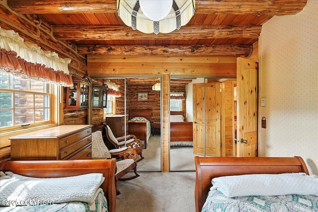 34035 Keystone Dr, Soldotna, AK 99669 - carpeted bedroom with a wooden ceiling with exposed beams, multiple windows, rustic walls, and wallpapered walls