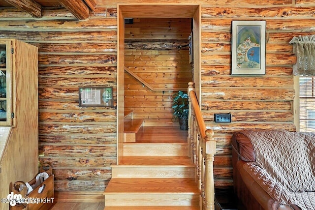 34035 Keystone Dr, Soldotna, AK 99669 - stairway with wood finished floors, log walls, and beamed ceiling