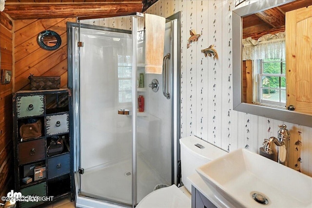 34035 Keystone Dr, Soldotna, AK 99669 - bathroom featuring a stall shower, wood walls, and vanity