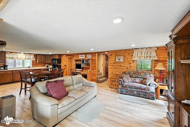 34035 Keystone Dr, Soldotna, AK 99669 - living room with a textured ceiling, plenty of natural light, light wood finished floors, recessed lighting, and wood walls