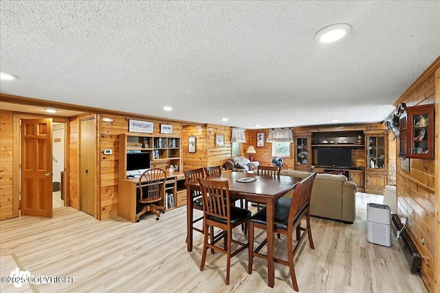 34035 Keystone Dr, Soldotna, AK 99669 - dining space with a textured ceiling, light wood-style floors, wood walls, and recessed lighting