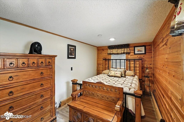34035 Keystone Dr, Soldotna, AK 99669 - bedroom featuring light wood finished floors, wooden walls, crown molding, and a textured ceiling