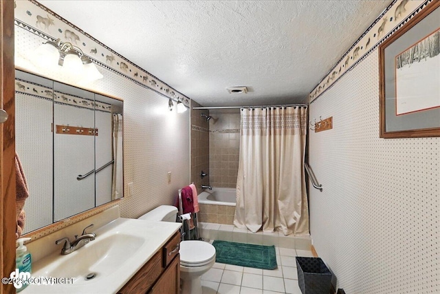 34035 Keystone Dr, Soldotna, AK 99669 - bathroom with tile patterned floors, vanity, a textured ceiling, and tiled shower / bath combo