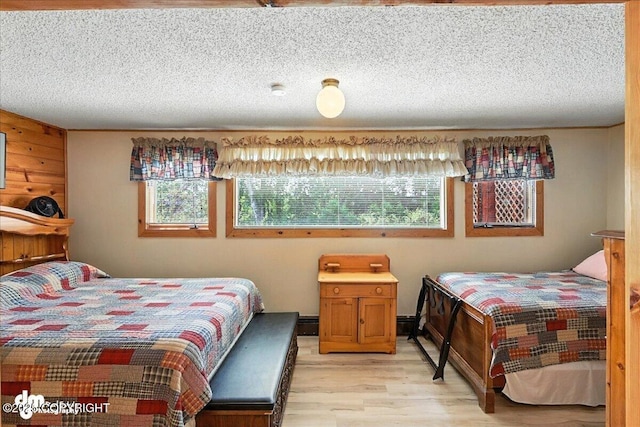 34035 Keystone Dr, Soldotna, AK 99669 - bedroom featuring multiple windows, light wood-style flooring, and a textured ceiling