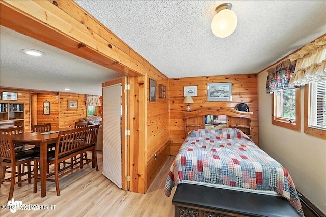 34035 Keystone Dr, Soldotna, AK 99669 - bedroom featuring a textured ceiling, wood walls, wood finished floors, and recessed lighting