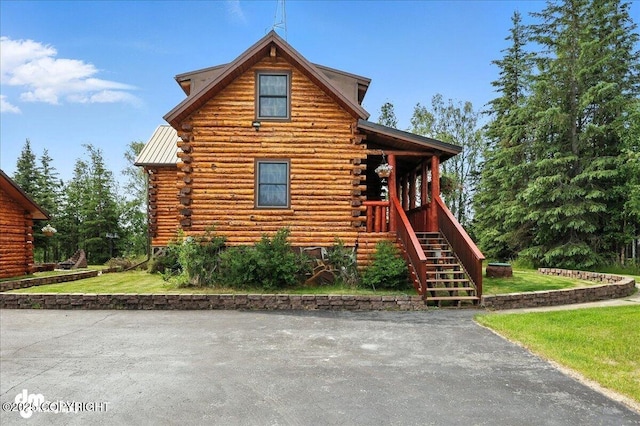 34035 Keystone Dr, Soldotna, AK 99669 - log cabin featuring log siding, stairway, and a front yard