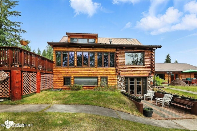 34035 Keystone Dr, Soldotna, AK 99669 - rear view of house with log exterior, a yard, a patio, a metal roof, and a wooden deck