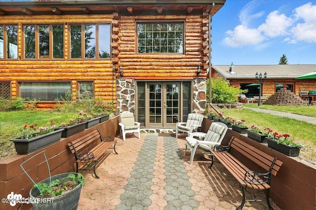 34035 Keystone Dr, Soldotna, AK 99669 - back of house with log siding, a patio, french doors, and stone siding