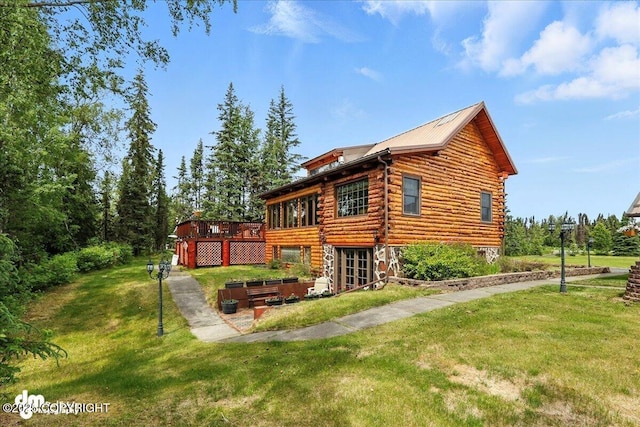 34035 Keystone Dr, Soldotna, AK 99669 - back of house with a wooden deck, a yard, log exterior, and a patio area