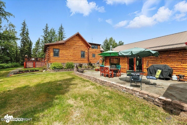34035 Keystone Dr, Soldotna, AK 99669 - back of property with log exterior, a yard, a patio, and a deck