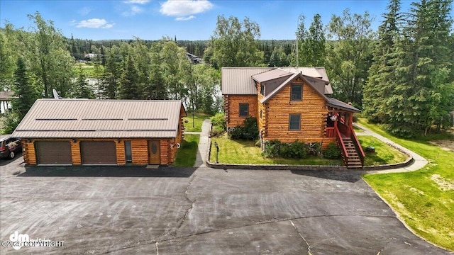34035 Keystone Dr, Soldotna, AK 99669 - log cabin with log exterior, a front yard, a metal roof, stairs, and a view of trees