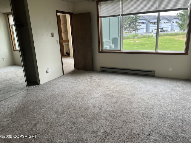 302 Sweetgale Ct # 302, Anchorage, AK 99518 - unfurnished bedroom featuring a baseboard heating unit and carpet