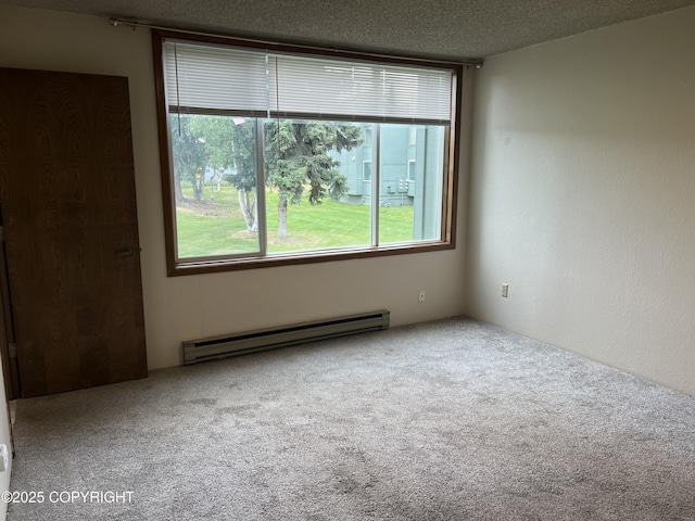 302 Sweetgale Ct # 302, Anchorage, AK 99518 - spare room with a baseboard radiator, carpet, and a textured ceiling