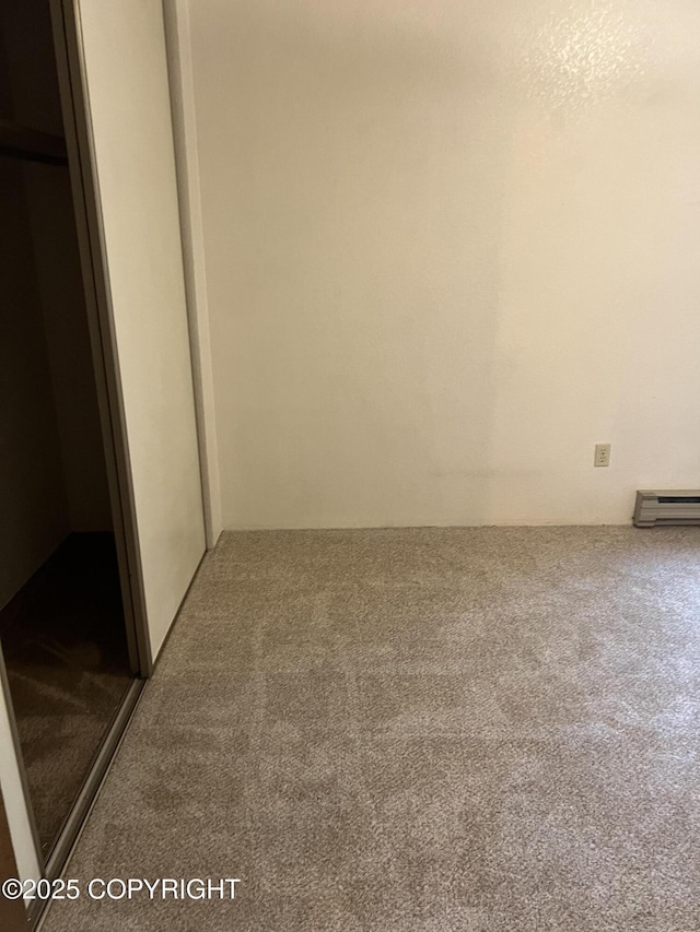 302 Sweetgale Ct # 302, Anchorage, AK 99518 - unfurnished bedroom with carpet flooring and a baseboard radiator