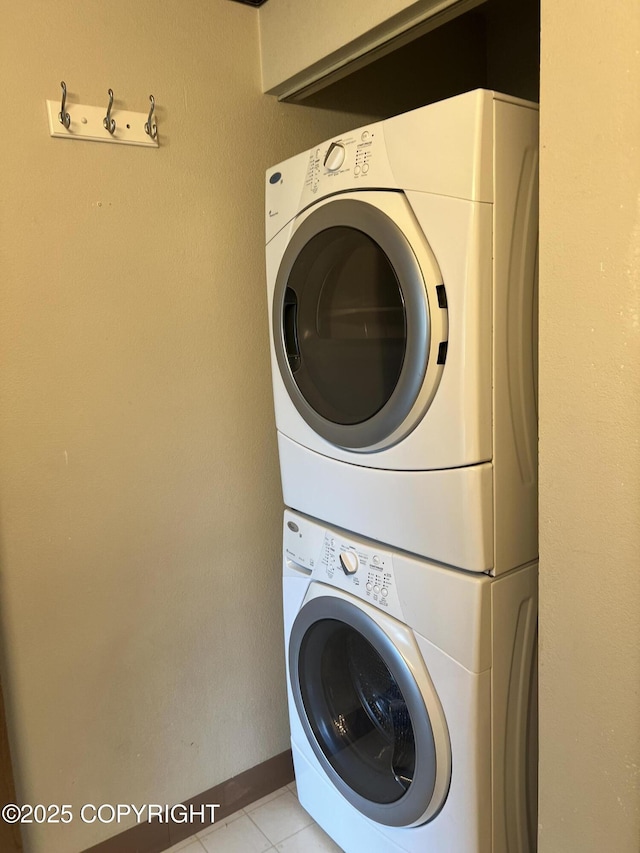 302 Sweetgale Ct # 302, Anchorage, AK 99518 - laundry area featuring stacked washer and clothes dryer and light tile patterned flooring