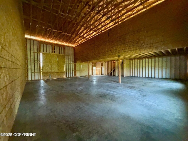 000 Kalifornsky Beach Rd, Soldotna, AK 99669 - miscellaneous room featuring unfinished concrete floors, a towering ceiling, and a garage