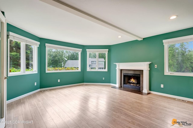2701 Kempton Hills Dr, Anchorage, AK 99516 - unfurnished living room with plenty of natural light, a high end fireplace, wood finished floors, recessed lighting, and beamed ceiling