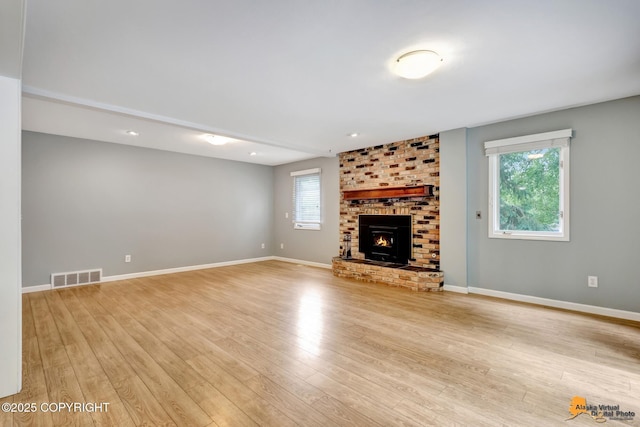 2701 Kempton Hills Dr, Anchorage, AK 99516 - unfurnished living room with healthy amount of natural light, light wood finished floors, a fireplace, and recessed lighting