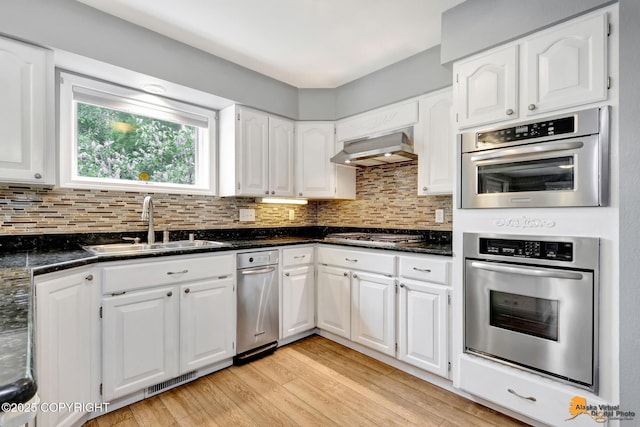 2701 Kempton Hills Dr, Anchorage, AK 99516 - kitchen with extractor fan, stainless steel appliances, white cabinets, and light wood finished floors