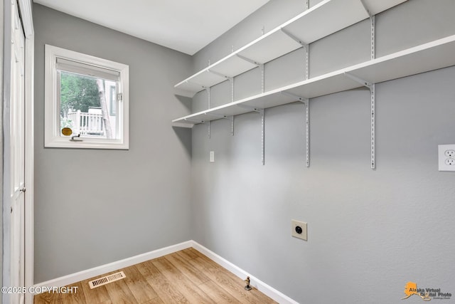 2701 Kempton Hills Dr, Anchorage, AK 99516 - laundry room with hookup for an electric dryer, light wood finished floors, and hookup for a gas dryer
