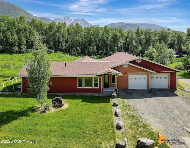 23324 Greatland Dr, Chugiak, AK 99577 - ranch-style house featuring a mountain view, gravel driveway, a garage, and a front yard