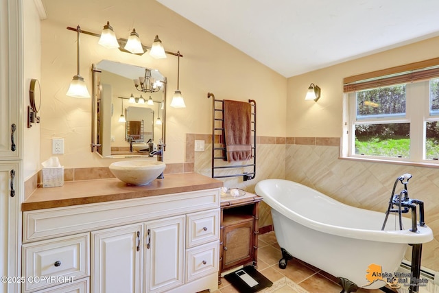 23324 Greatland Dr, Chugiak, AK 99577 - full bathroom with a freestanding tub, vanity, tile patterned flooring, a chandelier, and baseboard heating