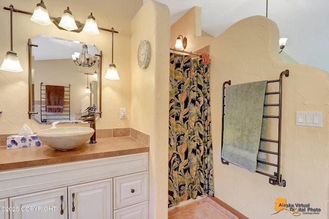 23324 Greatland Dr, Chugiak, AK 99577 - full bath with vanity, curtained shower, and a chandelier