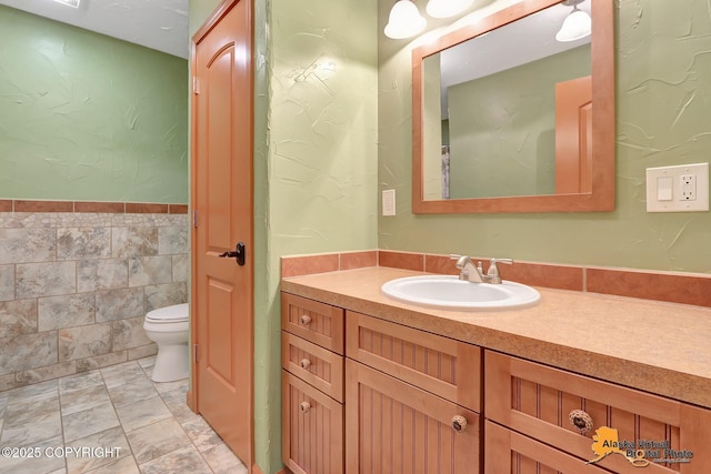 23324 Greatland Dr, Chugiak, AK 99577 - bathroom with vanity, tile walls, and wainscoting